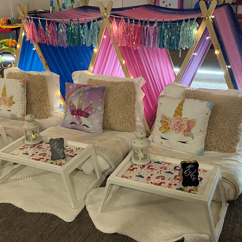 Unicorn Dreams themed sleepover fort party setup